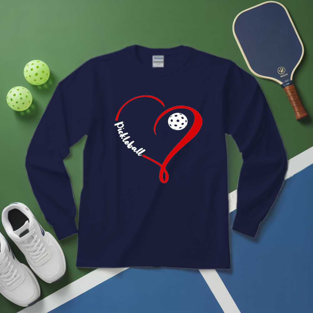 Navy blue long-sleeve shirt with pickleball design on a green and blue surface with pickleballs and a paddle.