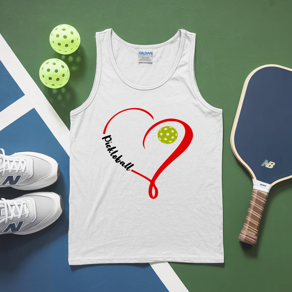 White tank top with pickleball design, pickleballs, and paddle on a green and blue surface