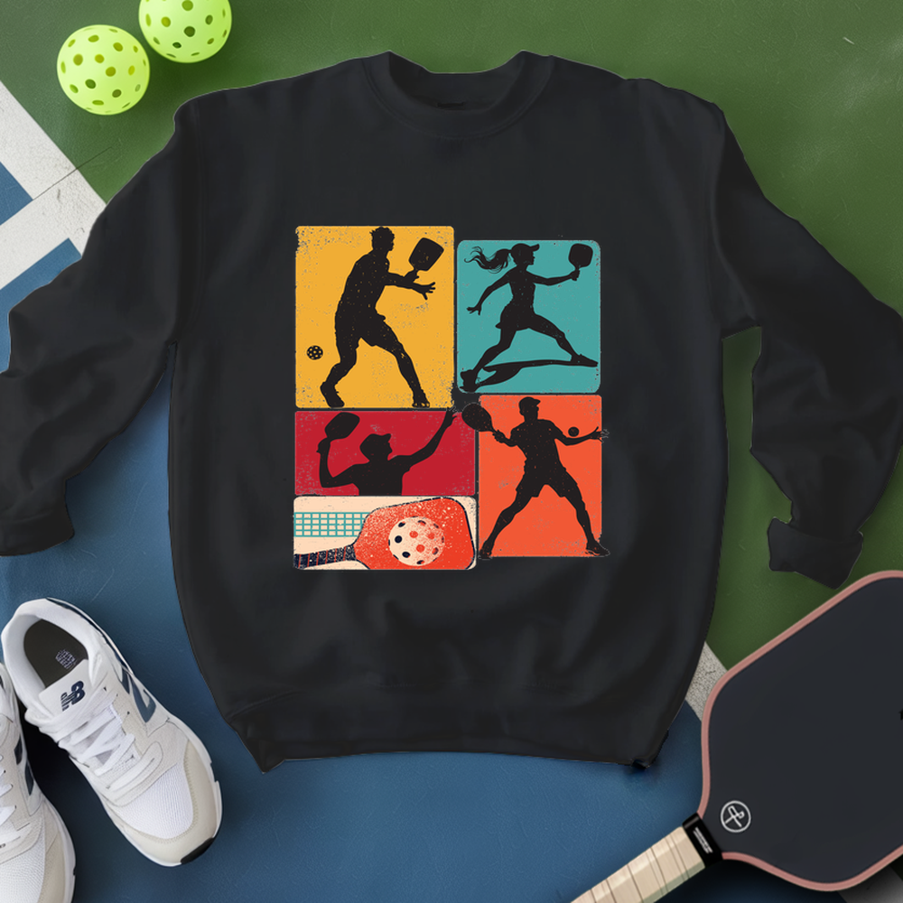 Black sweatshirt with pickleball design on a blue and green background