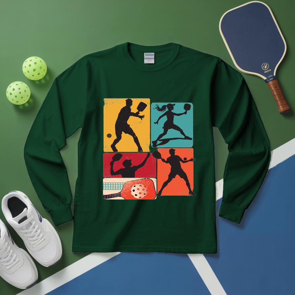 Green long-sleeve shirt with pickleball design on a green and blue surface with pickleball equipment.