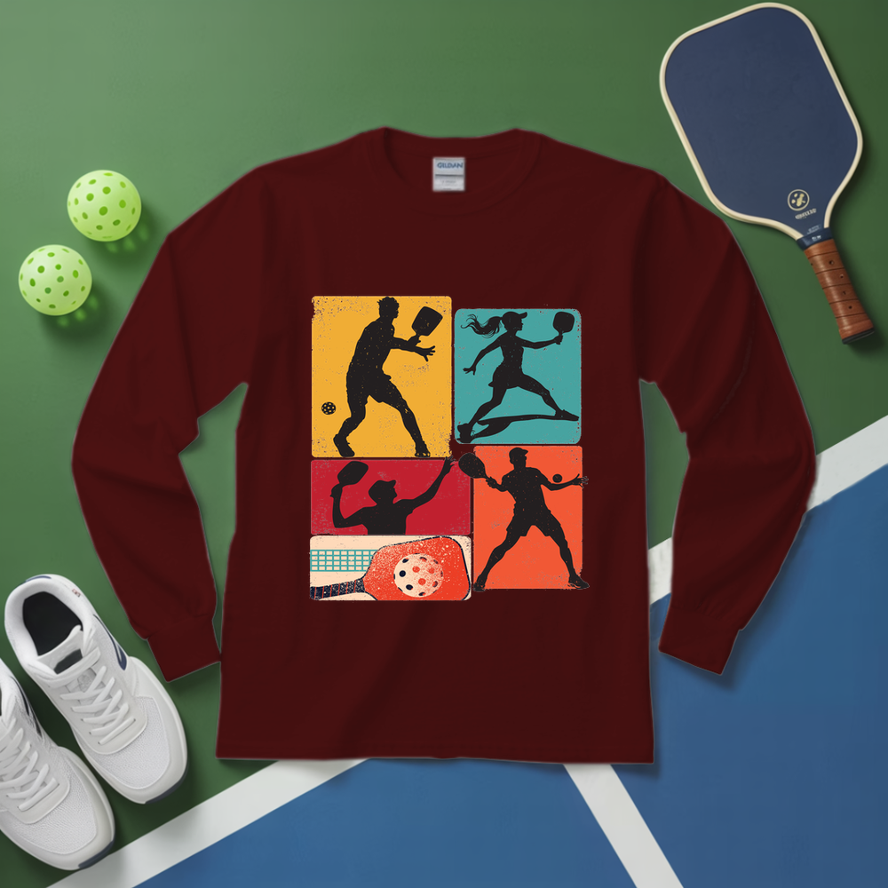 Maroon long-sleeve shirt with pickleball design on a green and blue surface with pickleballs and a paddle.