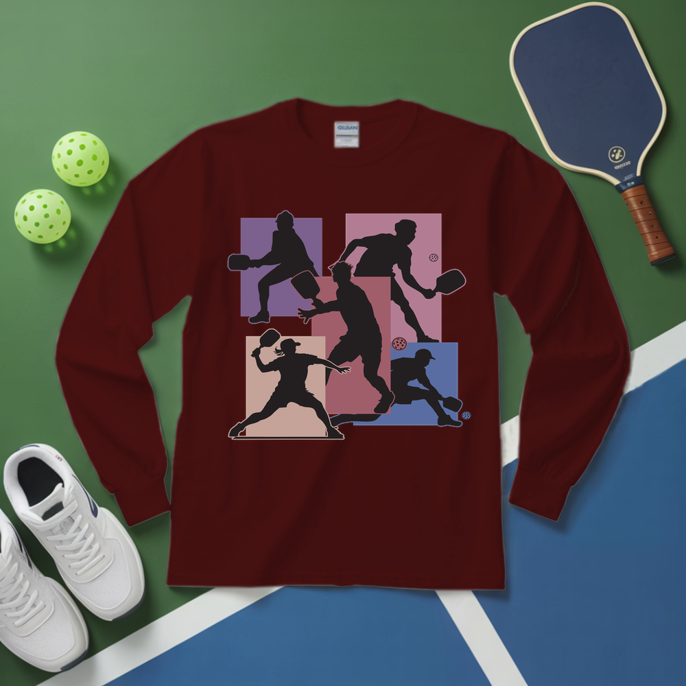 Maroon long-sleeve shirt with pickleball player design on a green and blue surface with pickleballs and a paddle.