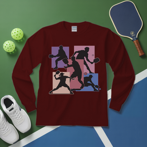 Maroon long-sleeve shirt with pickleball player design on a green and blue surface with pickleballs and a paddle.