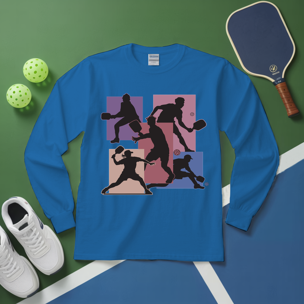 Blue long-sleeve shirt with pickleball player design on a green and blue background with pickleballs and paddle.