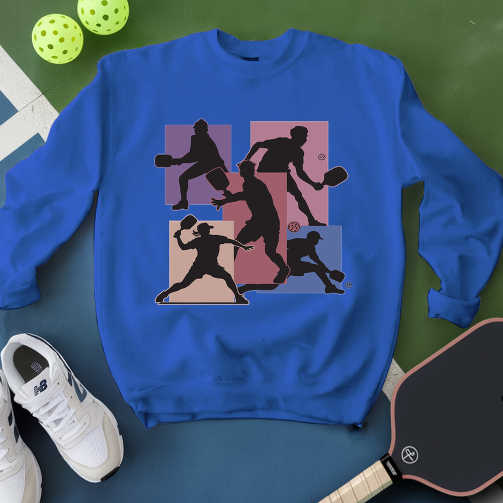 Blue sweatshirt with pickleball player design on a green and blue background