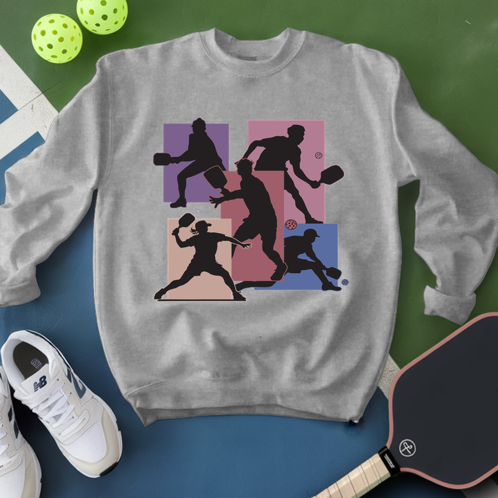 Gray sweatshirt with pickleball player design on a green and blue background
